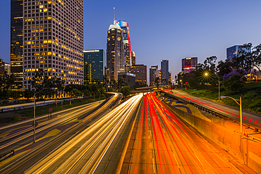 View of Downtown skyline and Harbour Freeway at dusk, Los Angeles, California, United States of America, North America