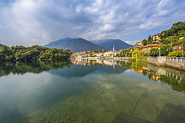 View of Mergozzo reflecting in Lake Mergozo, Piedmont, Italy, Europe