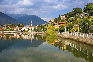 View of Mergozzo reflecting in Lake Mergozo, Piedmont, Italy, Europe