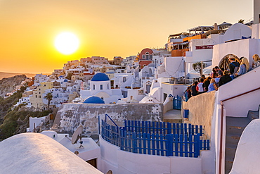 View of traditional blue domed churches and white houses at sunset in Oia, Santorini, Cyclades, Aegean Islands, Greek Islands, Greece, Europe