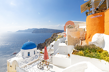 View of blue domed church from cafe in Oia village, Santorini, Cyclades, Aegean Islands, Greek Islands, Greece, Europe