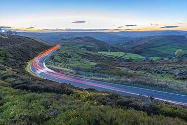 Light trails on road through Peak District National Park, England, Europe