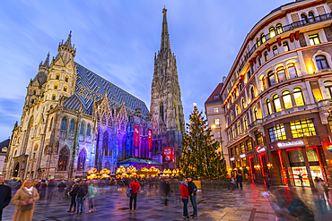View of St. Stephen's Cathedral, shops and Christmas tree on Stephanplatz at dusk, Vienna, Austria, Europe