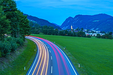 Trail lights and illuminated church in Radstadt at dusk, Radstadt, Styria, Austria, Europe