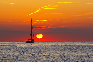 View of sunset and sailboat on Adriatic Sea from the old town, Rovinj, Istria, Croatia, Adriatic, Europe