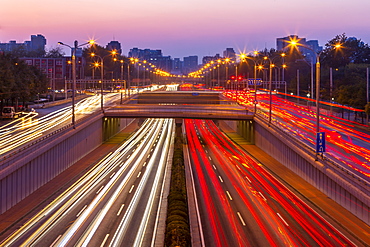 Traffic trail lights on major road near Beijing Zoo at dusk, Beijing, People's Republic of China, Asia