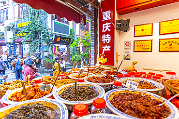 Busy shopping street and local food on display in Ciqikou Old Town, Shapingba, Chongqing, China, Asia