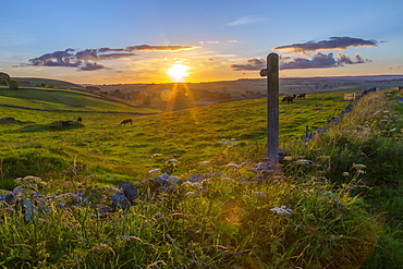 View of sunset, footpath sign and countryside near Wardlow, Peak District National Park, Derbyshire, England, United Kingdom, Europe