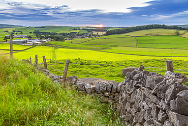 View of sunset and dry stone wall overlooking Peak Forest, Peak District National Park, Derbyshire, England, United Kingdom, Europe