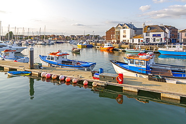 View of harbour boats and quayside houses, Weymouth, Dorset, England, United Kingdom, Europe