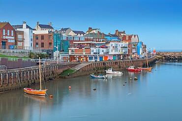 View of harbour boats and harbourside shops in Bridlington Harbour at dusk, Bridlington, East Yorkshire, England, United Kingdom, Europe