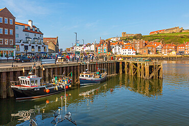 View of St. Mary's Church, houses and boats on the River Esk, Whitby, Yorkshire, England, United Kingdom, Europe