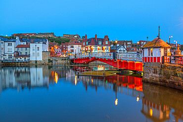 View of Whitby Bridge and reflections on River Esk at dusk, Whitby, Yorkshire, England, United Kingdom, Europe