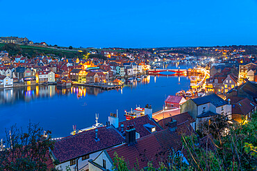 View of Whitby Bridge from across River Esk at dusk, Whitby, Yorkshire, England, United Kingdom, Europe