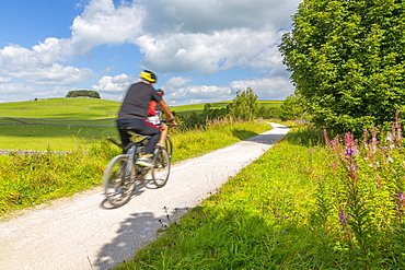 View of cyclist on the Tissington Trail, Tissington, Peak District National Park, Derbyshire, England, United Kingdom, Europe