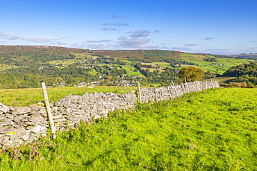 View of dry stone wall and Calver Village overlooked by Curbar Edge, Calver, Derbyshire Peak District, Derbyshire, England, United Kingdom, Europe