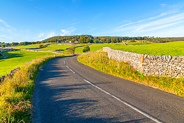 View of dry stone walls on country lane, Foolow, Derbyshire Peak District, Derbyshire, England, United Kingdom, Europe