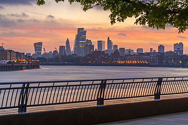 View of The City skyline at sunset from the Thames Path, London, England, United Kingdom, Europe