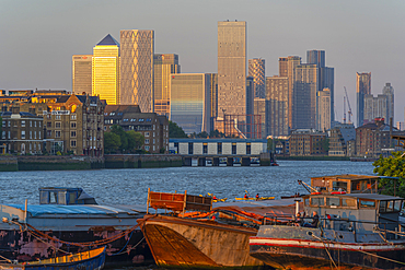 View of Thames barges, Docklands and Canary Wharf at sunset, London, England, United Kingdom, Europe