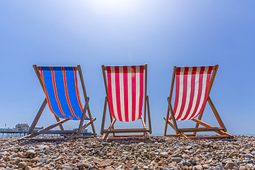 View of Worthing Pier and colourful deckchairs on Worthing Beach, Worthing, West Sussex, England, United Kingdom, Europe