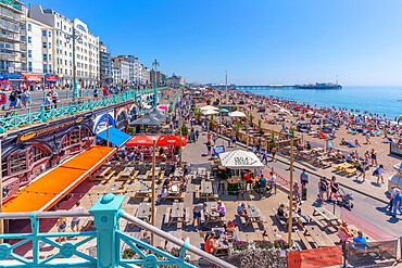 View of beach, seafront cafe and Brighton Palace Pier on a sunny day, Brighton, East Sussex, England, United Kingdom, Europe