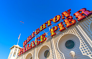 View of paraglider and sign on a sunny day on Brighton Palace Pier, Brighton, East Sussex, England, United Kingdom, Europe