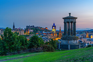 View of Edinburgh Castle, Balmoral Hotel and Dugald Stewart monument from Calton Hill at dusk, UNESCO World Heritage Site, Edinburgh, Lothian, Scotland, United Kingdom, Europe