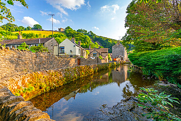 View of Castleton village and stream overlooked by Peveril Castle, Hope Valley, Peak District National Park, Derbyshire, England, United Kingdom, Europe