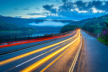 View of trail lights on Ladybower Reservoir bridge at dusk, Peak District National Park, Derbyshire, England, United Kingdom, Europe