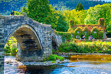 View of Pont Fawr (Inigo Jones Bridge) over Conwy River and cafe, Llanrwst, Clwyd, Snowdonia, North Wales, United Kingdom, Europe