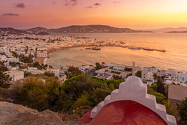 View of chapel and town from elevated view point at sunset, Mykonos Town, Mykonos, Cyclades Islands, Greek Islands, Aegean Sea, Greece, Europe