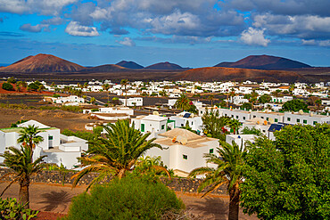 View of town from elevated position with mountainous backdrop, Yaisa, Lanzarote, Canary Islands, Spain, Atlantic, Europe