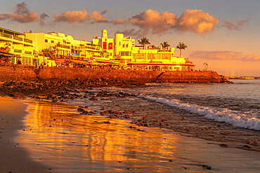 View of beach and cafes and bars during golden hour, Playa Blanca, Lanzarote, Canary Islands, Spain, Atlantic, Europe