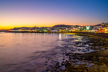 View of beach and cafes and bars at dusk, Playa Blanca, Lanzarote, Canary Islands, Spain, Atlantic, Europe