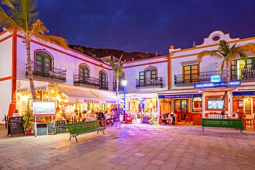 View of cafes and restaurants in Puerto de Mogan and mountainous background at dusk, Puerto de Mogan, Gran Canaria, Canary Islands, Spain, Atlantic, Europe