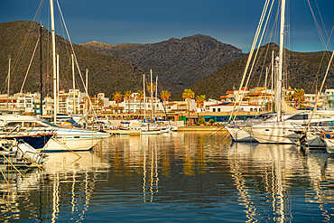 View of sunrise reflecting on yachts in Port de Pollenca Marina, Port de Pollenca, Majorca, Balearic Islands, Spain, Mediterranean, Europe