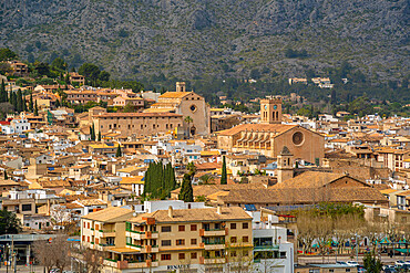 View of churches and rooftops of Pollenca in mountainous setting, Pollenca, Majorca, Balearic Islands, Spain, Mediterranean, Europe