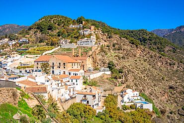 View of white washed houses and mountains in background, Frigiliana, Malaga Province, Andalucia, Spain, Europe