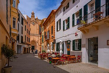 View of cafe in street iand cathedral in background, Ciutadella, Memorca, Balearic Islands, Spain, Europe