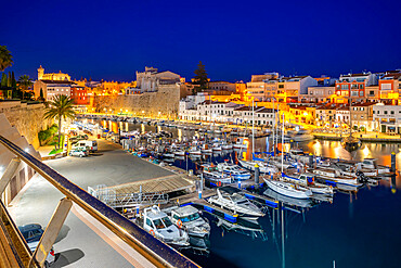 View of boats in marina overlooked by whitewashed buildings at dusk, Ciutadella, Menorca, Balearic Islands, Spain, Mediterranean, Europe