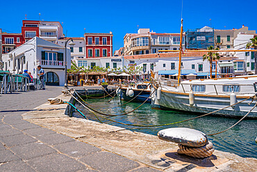 View of colourful cafes, restaurants and boats in harbour against blue sky, Cales Fonts, Menorca, Balearic Islands, Spain, Mediterranean, Europe