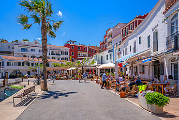 View of colourful cafes, restaurants in harbour against blue sky, Cales Fonts, Menorca, Balearic Islands, Spain, Mediterranean, Europe