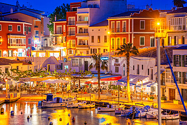 View of cafes, restaurants and boats in harbour at dusk, Cales Fonts, Es Castell, Menorca, Balearic Islands, Spain, Mediterranean, Europe