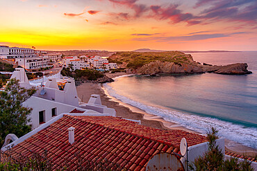 View of beach and rooftops at sunset in Arenal d'en Castell, Es Mercadal, Menorca, Balearic Islands, Spain, Mediterranean, Europe