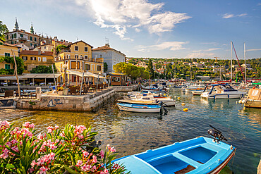 View of boats in the marina and harbourside restaurants during golden hour in Volosko, Opatija, Kvarner Bay, Croatia, Europe