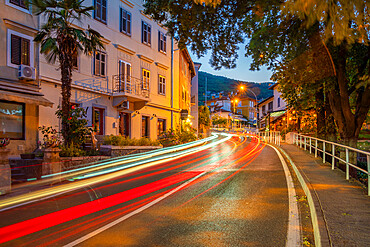 View of hotels and trail lights at dusk, Lovran, Kvarner Bay, Eastern Istria, Croatia, Europe