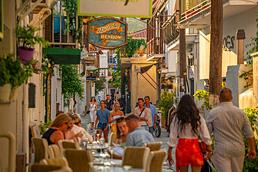 View of alfresco eating in narrow street, Skiathos Town, Skiathos Island, Sporades Islands, Greek Islands, Greece, Europe