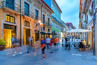 View of busy street with cafes and bars in old town Porto at dusk, Porto, Norte, Portugal, Europe