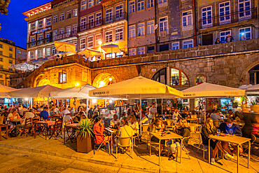 View of bars and restaurants at waterfront of Douro River at dusk, Porto, Norte, Portugal, Europe