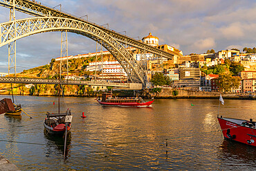 View of boats, Dom Luis I Bridge, UNESCO World Heritage Site, and Douro River at sunset, Porto, Norte, Portugal, Europe